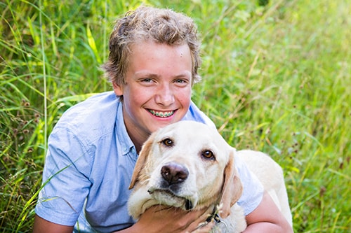 Boy with dog Maryville Family Orthodontics in Maryville, TN